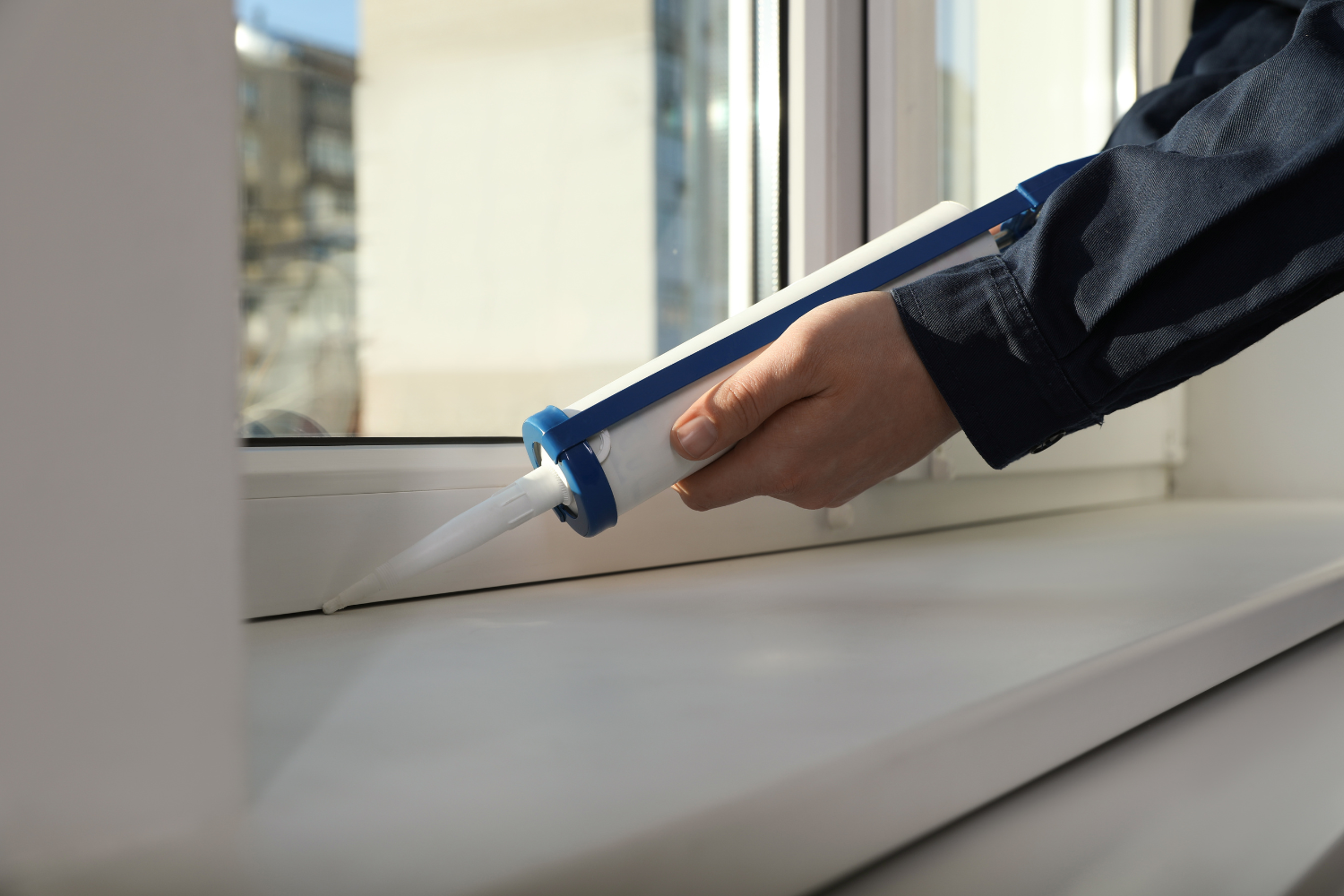 Airtight window seal being checked for drafts to extend the lifespan of windows