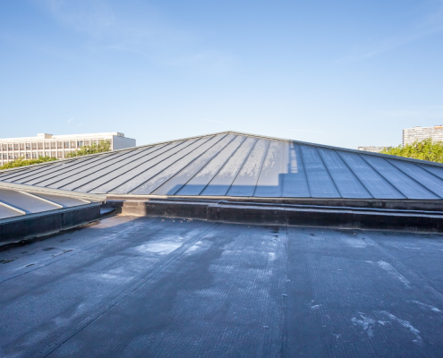 Flat and metal roof combination