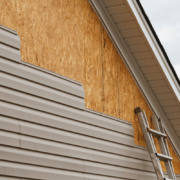 Environmental impact illustration of wood vs vinyl siding.