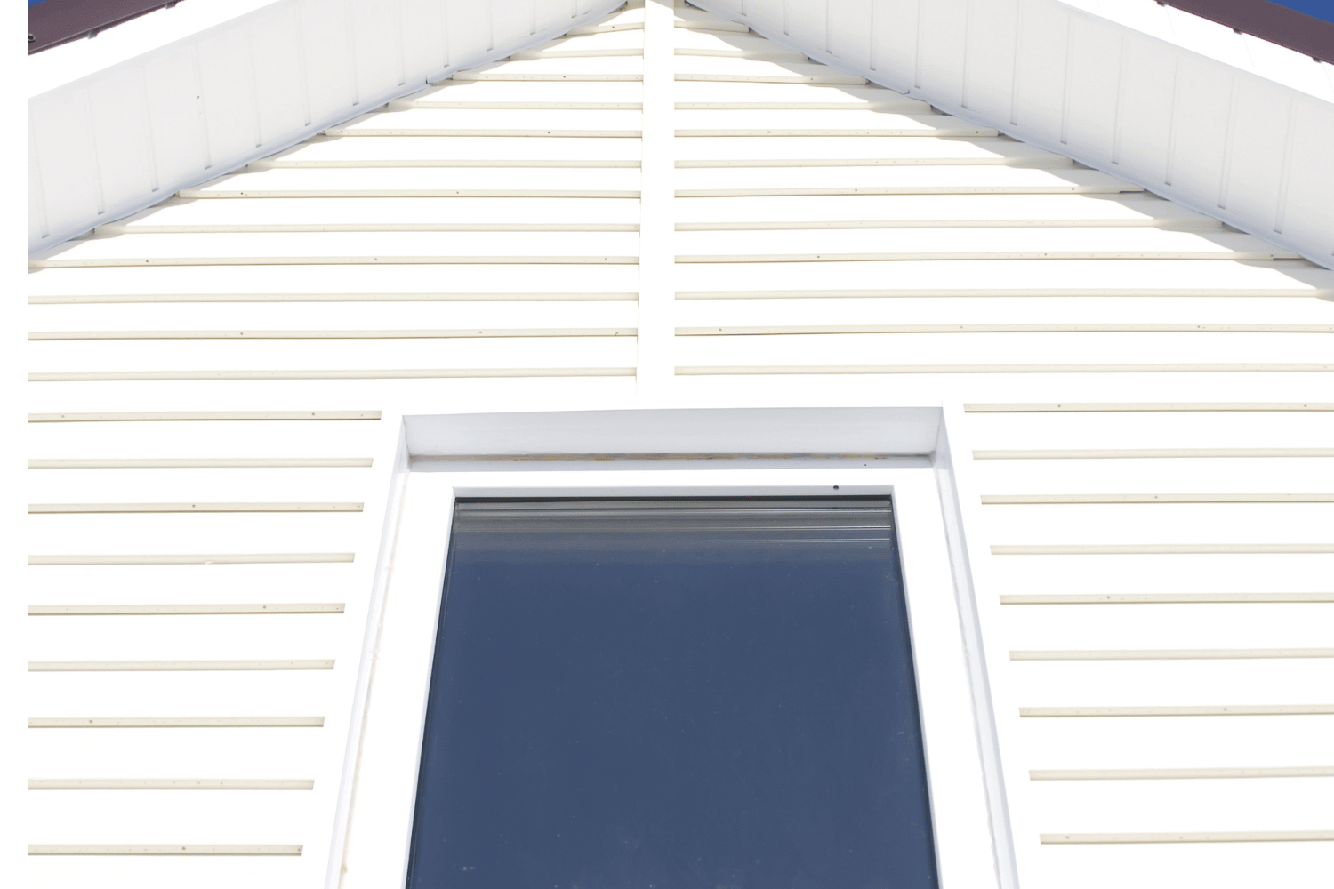 An attractive house with enhanced curb appeal through a combination of metal roofing and vinyl siding. 