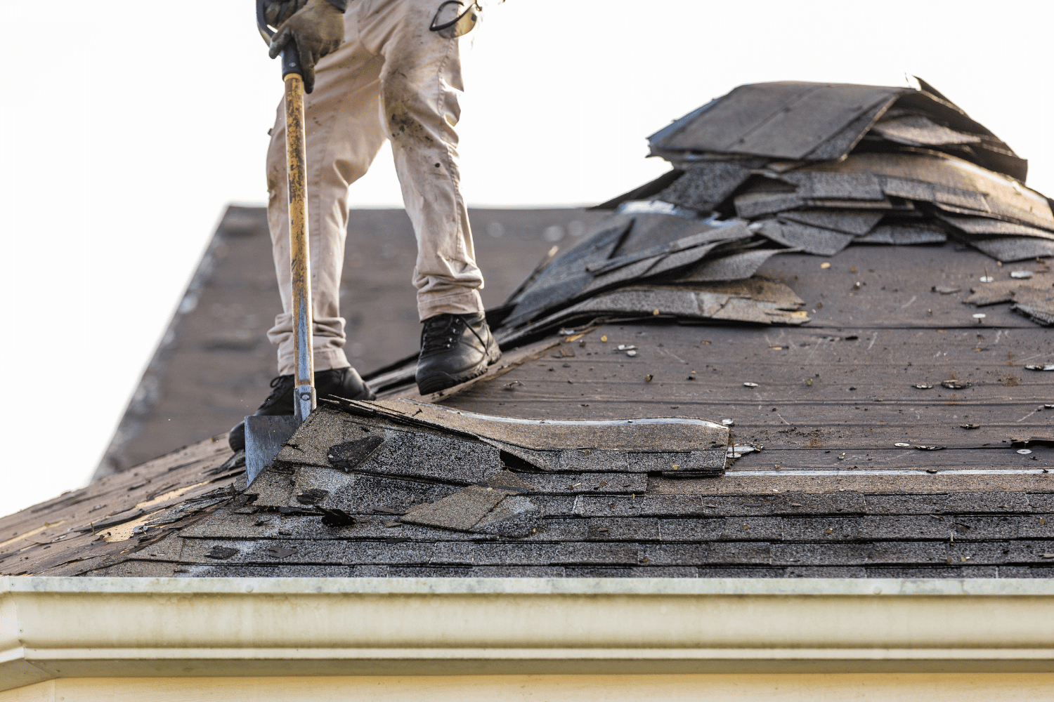 An image depicting the process of shingle removal from a roof. 