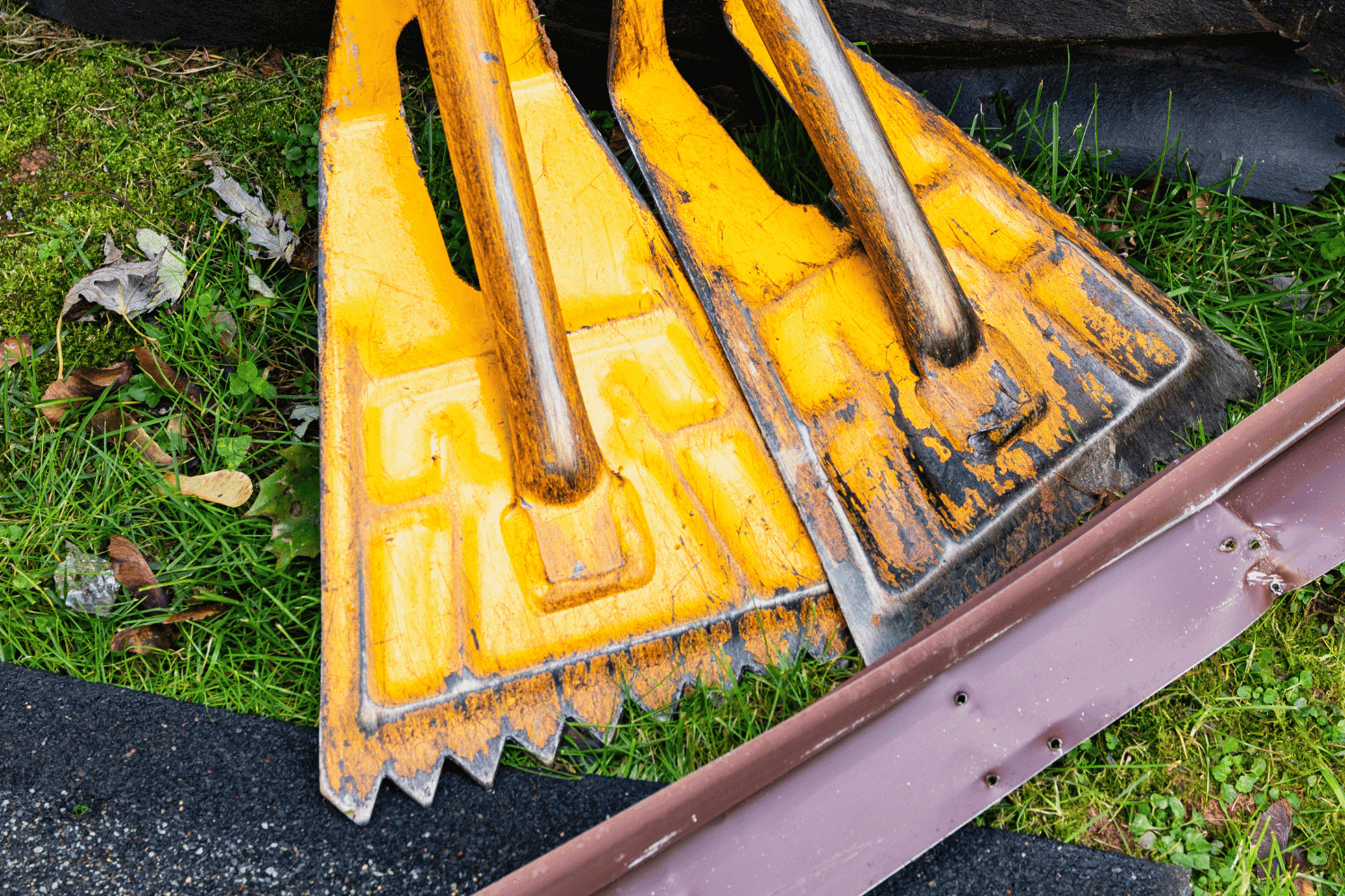 Cleaning up after shingle removal with debris and tools displayed. 