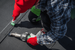 A close-up of an EPDM roofing system installation showcasing the rubber membrane.