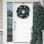 A professional technician assessing a front door for repair.