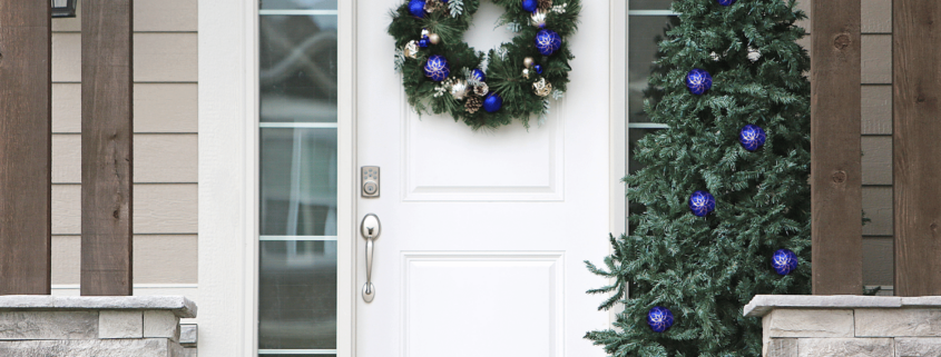 A professional technician assessing a front door for repair.