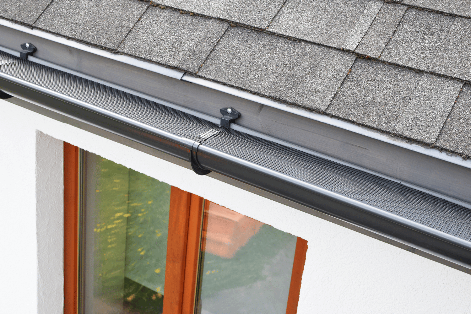 An overview of gutter splash guards installed on a house.