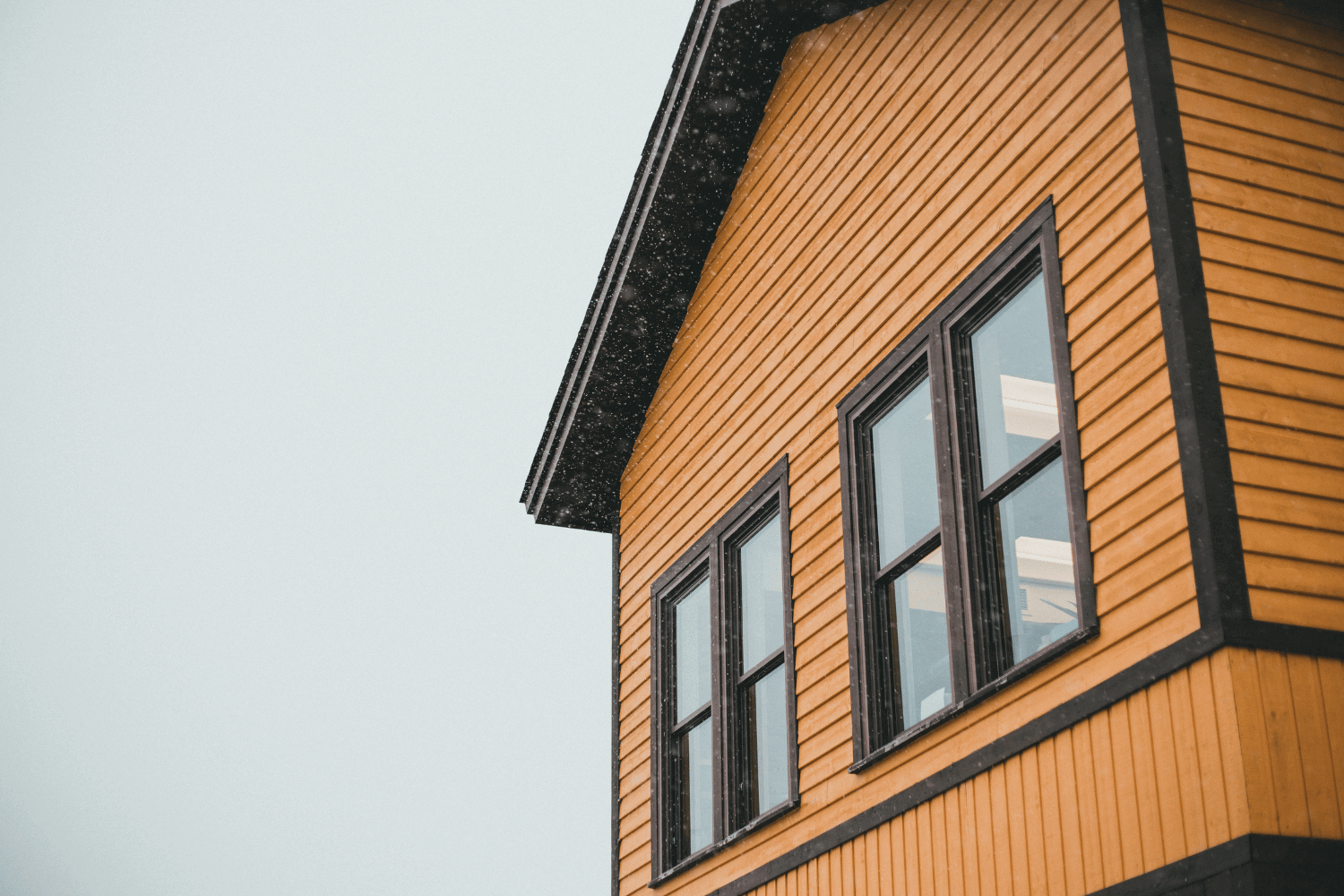 A side-by-side comparison of board and batten vs lap siding on two different homes. 