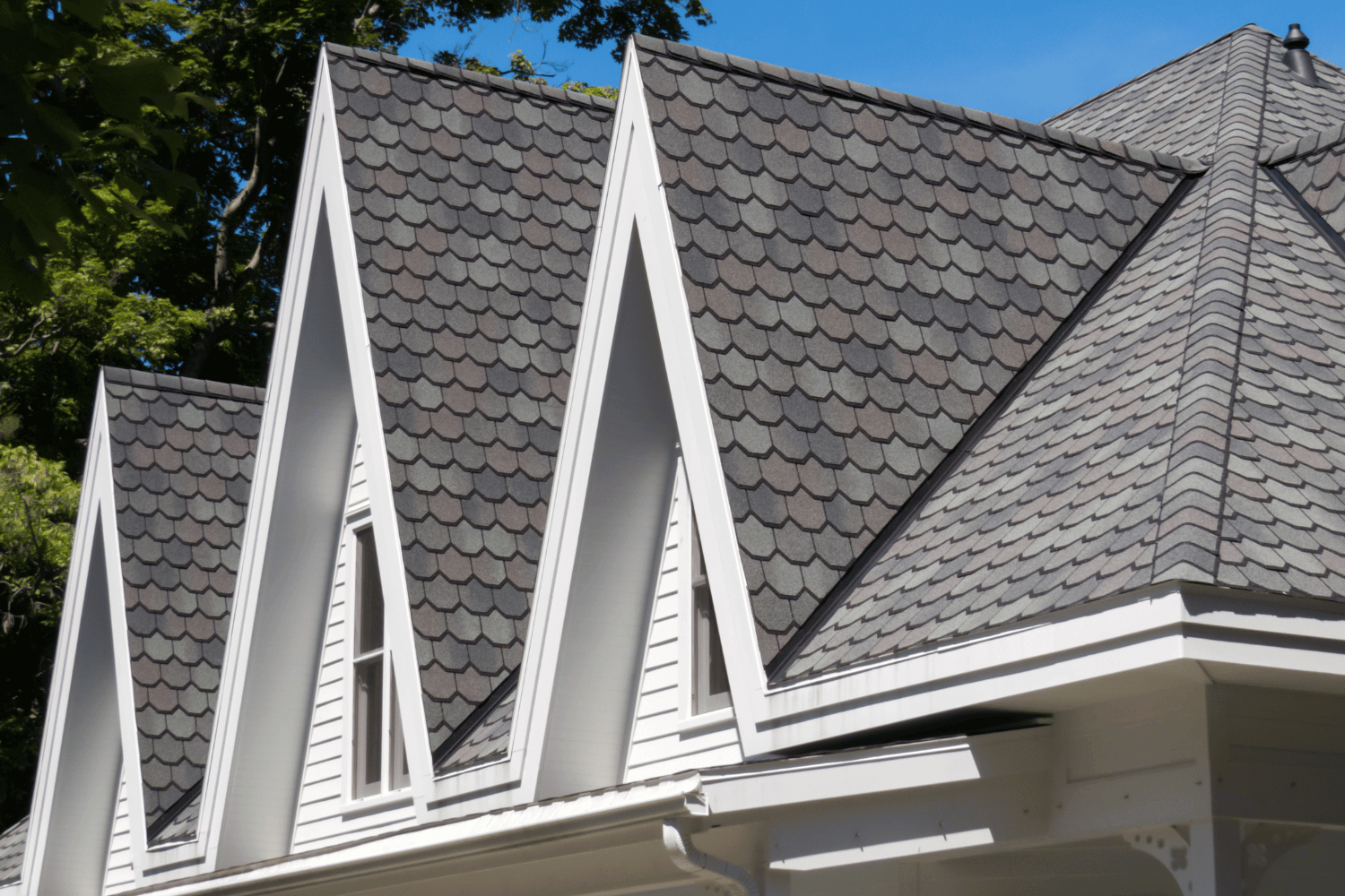 Different types of gable roofs displayed on various homes. 