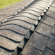 Before and after images of a roof treated with shingle sealant.