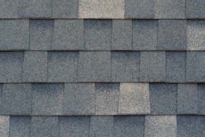 Close-up texture of dark gray asphalt roofing shingles