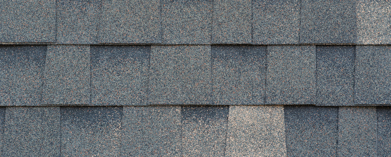 Close-up texture of dark gray asphalt roofing shingles