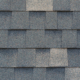 Close-up texture of dark gray asphalt roofing shingles