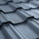 A close-up view of interlocking metal roofing panels showcases their superior construction quality, highlighting the durability and low maintenance benefits of metal roofs compared to traditional asphalt shingles. This image emphasizes the importance of choosing the best roofing materials for mid-Missouri homeowners facing extreme weather conditions.