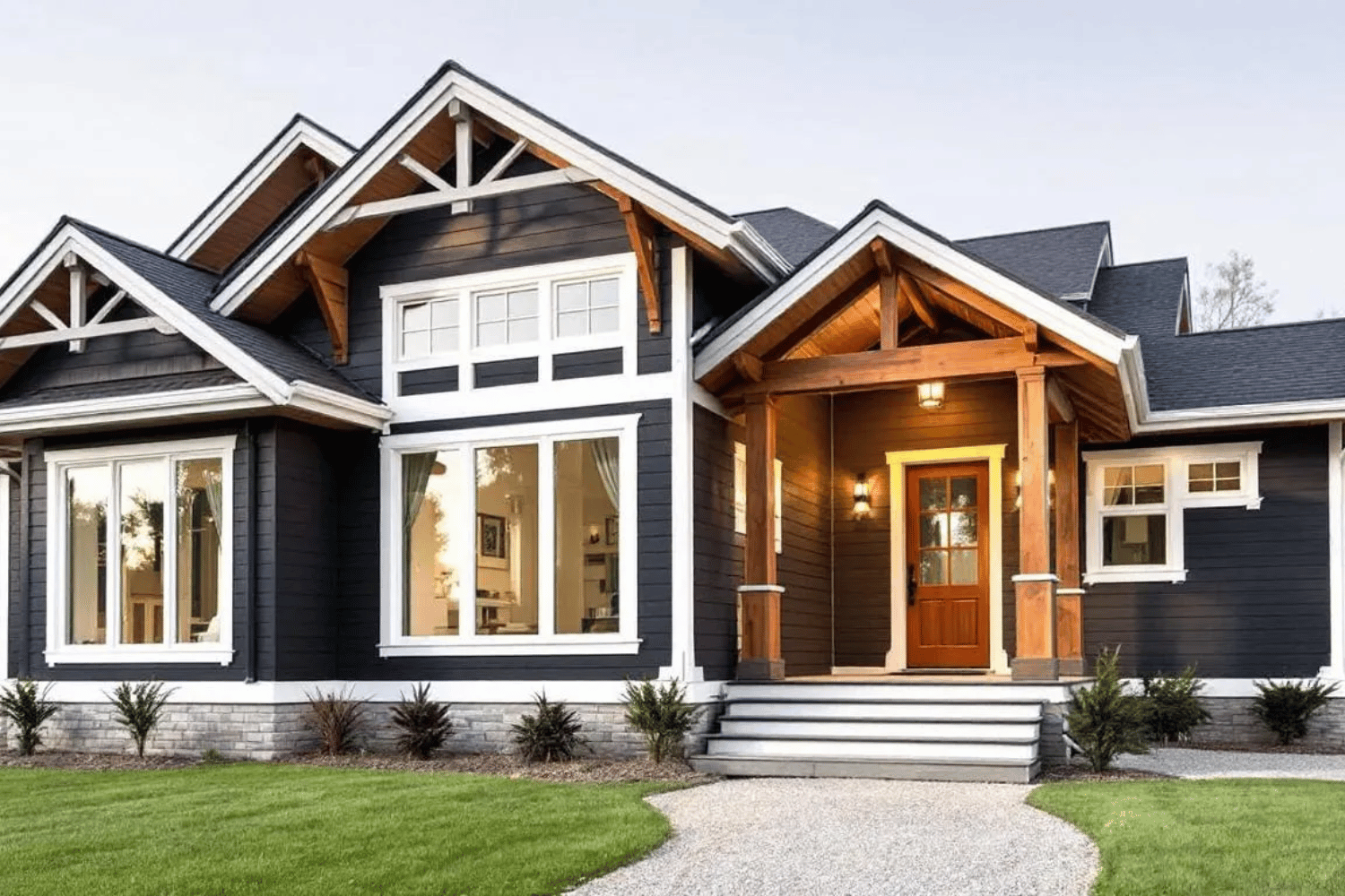 This elegant home showcases deep charcoal siding complemented by classic white trim and natural wood accents, creating a striking contrast that enhances the home's curb appeal. The combination of earthy tones and modern design elements reflects a timeless appeal, making it an ideal choice for homeowners looking to elevate their home's exterior.