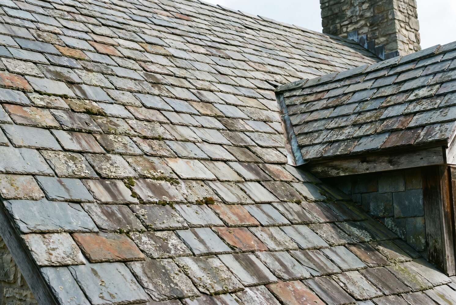 Close-up of natural slate roof tiles showing gray and blue-gray color variations on a historic Jefferson City Missouri home